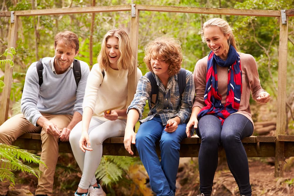A family in the woods happy after getting mental health treatment in New Jersey