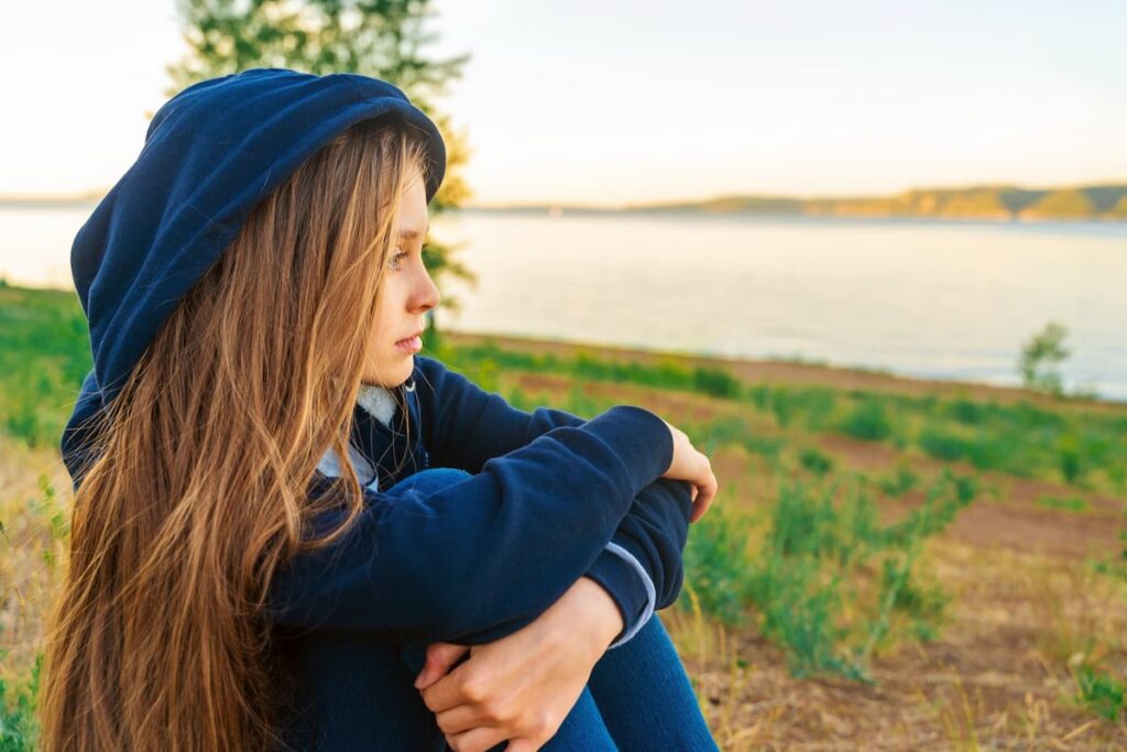 A teenage girl contemplating therapy for her mental health in New Jersey