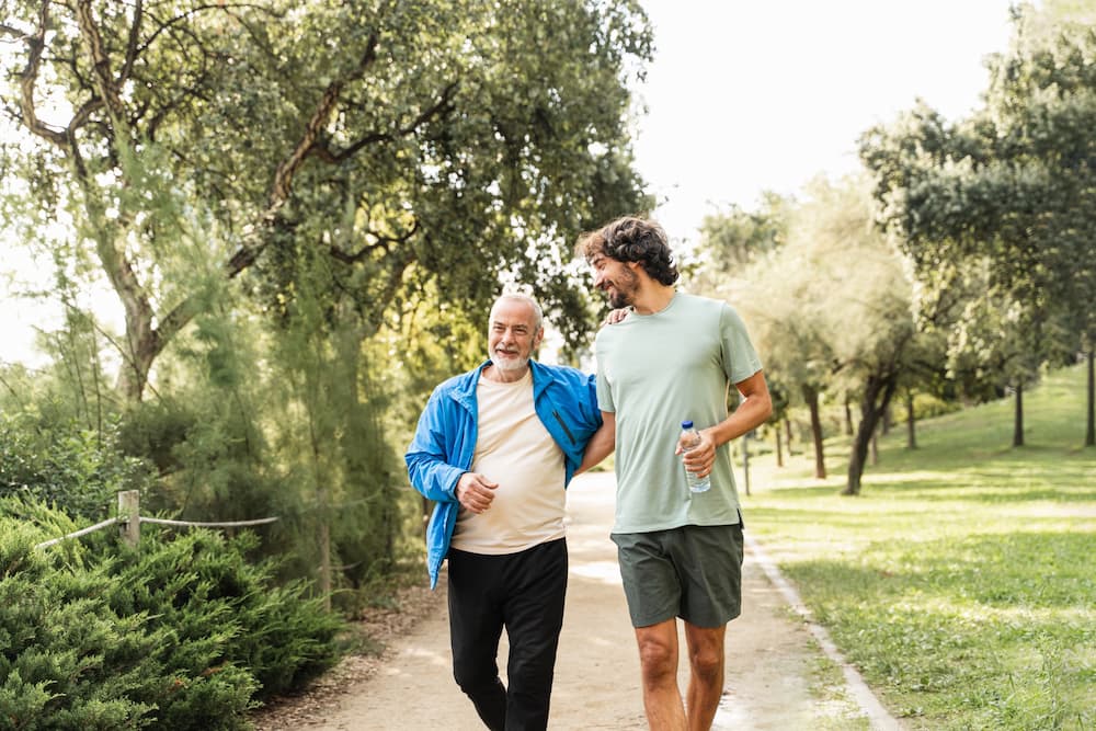 Man walking with elderly man for their mental health