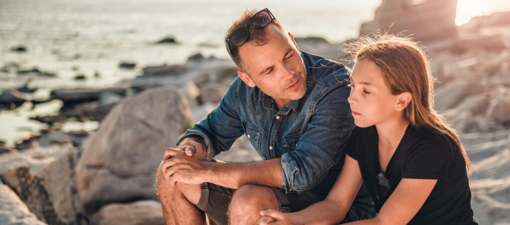 Father and his daughter discussing adolescent mental health treatment in NJ