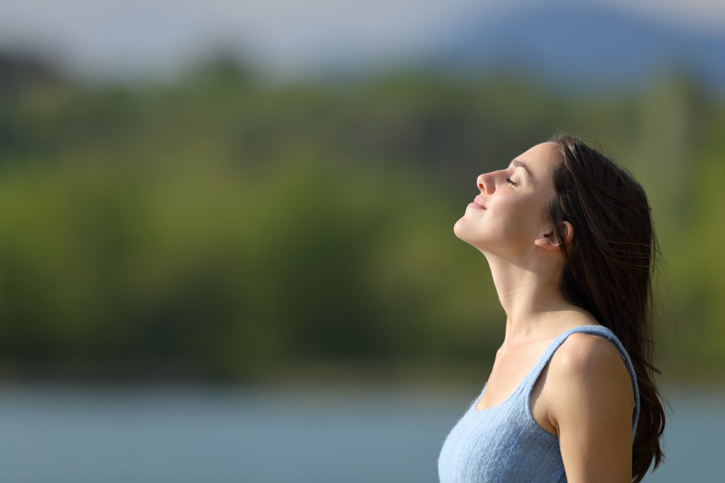 A teenage girl happy outside after receiving adolescent mental health treatment in NJ