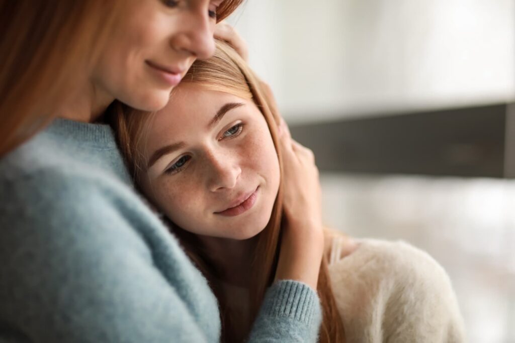 Mother holding her adolescent child after her trauma treatment in NJ